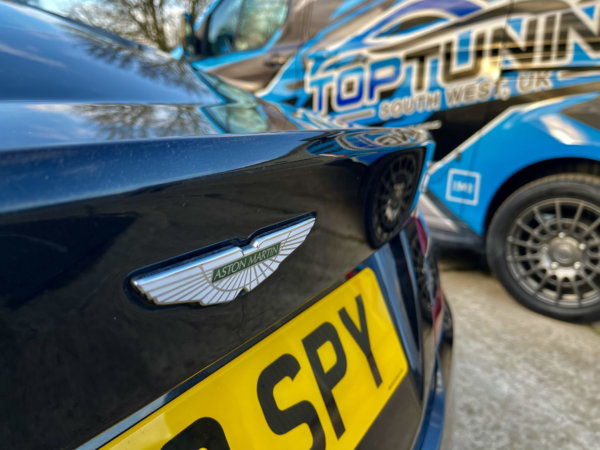 Close up of Aston Martin next to Top-tuning van